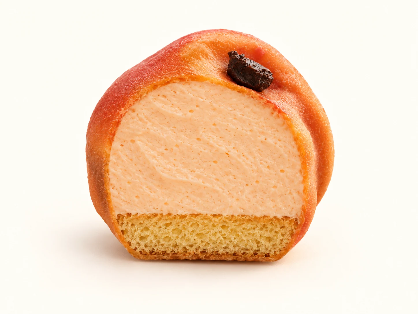 Coupe illustrative de L’Abricot : crème à l’abricot en partie haute, biscuit à l’abricot à la base.